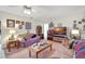 Cozy living room with comfortable seating, ceiling fan, and display of personal Gathering photos at 4610 47Th N Way, St Petersburg, FL 33702