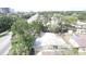 An aerial view of a home with a white roof, surrounded by lush greenery and a spacious yard at 4735 W Wisconsin Ave, Tampa, FL 33616
