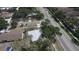 Aerial view of the neighborhood, near a paved road and surrounded by mature trees and some landscaping at 4735 W Wisconsin Ave, Tampa, FL 33616