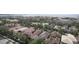 A high angle view of a residential community with diverse housing, lush trees, and a water view at 4735 W Wisconsin Ave, Tampa, FL 33616