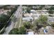 Aerial view of a home featuring mature trees, landscaping, a long driveway, and a detached garage at 4735 W Wisconsin Ave, Tampa, FL 33616