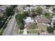 Aerial view of a home featuring mature trees, landscaping, a long driveway, and a detached garage at 4735 W Wisconsin Ave, Tampa, FL 33616