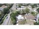 Aerial view of a home featuring mature trees, landscaping, a long driveway, and a detached garage at 4735 W Wisconsin Ave, Tampa, FL 33616
