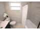 Elegant bathroom featuring marble-like tiles, a modern vanity, and a bathtub with a shower curtain at 4735 W Wisconsin Ave, Tampa, FL 33616