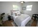 Inviting bedroom with a comfortable bed, decorative pillows, and natural light at 4735 W Wisconsin Ave, Tampa, FL 33616