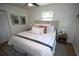 Bright bedroom featuring a comfortable bed with stylish pillows and a neutral headboard, complemented by matching nightstands at 4735 W Wisconsin Ave, Tampa, FL 33616
