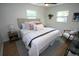 Cozy bedroom with a well-dressed bed, soft pillows, and warm lighting from bedside lamps at 4735 W Wisconsin Ave, Tampa, FL 33616