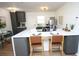 Modern kitchen with gray cabinets, white countertops, and stylish bar seating at 4735 W Wisconsin Ave, Tampa, FL 33616