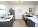 Open kitchen with updated stainless appliances, modern lighting, and ample counter space at 4735 W Wisconsin Ave, Tampa, FL 33616