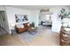 Inviting living room with a brown leather sofa, modern art, and wood flooring at 4735 W Wisconsin Ave, Tampa, FL 33616