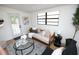 Bright sitting room with contemporary furniture, modern decor, and outdoor access at 4735 W Wisconsin Ave, Tampa, FL 33616
