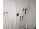 EcoSmart tankless water heater on white wall with pipes and connections in a utility area at 4735 W Wisconsin Ave, Tampa, FL 33616