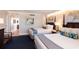 Bright hotel suite bedroom with two beds and a view to the sitting and dining area at 5500 Gulf Blvd # 2249, St Pete Beach, FL 33706