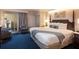 Hotel suite bedroom featuring a queen bed with unique lighting, and a view of the balcony at 5500 Gulf Blvd # 2249, St Pete Beach, FL 33706