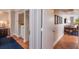 Hallway leading to an open living room and dining area with hardwood floors at 5500 Gulf Blvd # 2249, St Pete Beach, FL 33706