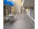 Outdoor patio features a glass table, four chairs, and walkway at 5500 Gulf Blvd # 2249, St Pete Beach, FL 33706