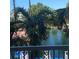 Scenic balcony view overlooking waterway with paddle boats and tropical palm trees at 5500 Gulf Blvd # 2249, St Pete Beach, FL 33706