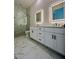 Elegant bathroom boasts double vanity, frameless glass shower, marble floors, and modern lighting at 600 3Rd S Ave # 503, St Petersburg, FL 33701