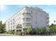 Modern apartment building featuring multiple balconies, neutral colors, and street-level landscaping at 600 3Rd S Ave # 503, St Petersburg, FL 33701