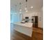 Modern kitchen with stainless steel appliances, white cabinetry, hardwood floors, and pendant lighting at 600 3Rd S Ave # 503, St Petersburg, FL 33701