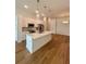 Beautiful kitchen with a large island, modern lighting, white cabinets, and stainless steel appliances at 600 3Rd S Ave # 503, St Petersburg, FL 33701