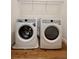 Efficient laundry room with modern washer, dryer, and overhead storage rack at 600 3Rd S Ave # 503, St Petersburg, FL 33701