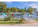 Charming blue single-story home featuring a white picket fence and well-manicured lawn at 6219 57Th N Ave, St Petersburg, FL 33709