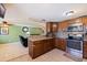 Well-lit kitchen featuring a breakfast bar that opens to a cozy living area at 6219 57Th N Ave, St Petersburg, FL 33709