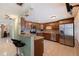 Open kitchen with stainless steel appliances, breakfast bar, and stylish tile backsplash at 6219 57Th N Ave, St Petersburg, FL 33709