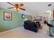 Bright living room with tile floors, fan and black leather sofa at 6219 57Th N Ave, St Petersburg, FL 33709