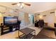 Inviting living room featuring tile floors, ceiling fan, and a cozy home office setup at 6219 57Th N Ave, St Petersburg, FL 33709