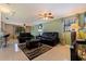 Spacious living room featuring tile floors, neutral walls, and a comfortable black sofa at 6219 57Th N Ave, St Petersburg, FL 33709