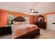 Comfortable main bedroom featuring warm walls and a decorative, large bed frame at 6219 57Th N Ave, St Petersburg, FL 33709