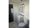 Bathroom features a white vanity with a sink and a white toilet at 6241 Westport Dr, Port Richey, FL 34668