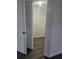 View of the closet with louvered doors in the bedroom with dark wood flooring at 6241 Westport Dr, Port Richey, FL 34668