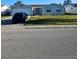 Charming single-story home featuring an attached garage and well-maintained front yard at 6241 Westport Dr, Port Richey, FL 34668