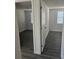 Bright hallway showcases gray wood floors and access to bedrooms with windows at 6241 Westport Dr, Port Richey, FL 34668