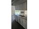 Kitchen featuring new flooring, granite counters, and modern fixtures at 6241 Westport Dr, Port Richey, FL 34668