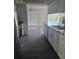 Modern kitchen with new flooring, white cabinets, and stainless steel appliances at 6241 Westport Dr, Port Richey, FL 34668