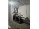 Functional laundry room with modern washer and dryer, utility sink, and storage at 6241 Westport Dr, Port Richey, FL 34668