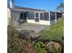 Screened patio area with a concrete slab and access to the backyard at 6241 Westport Dr, Port Richey, FL 34668