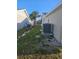 Side yard with AC units and a grassy area between two homes at 6241 Westport Dr, Port Richey, FL 34668