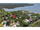 An aerial view shows the home nestled among lush greenery with a waterfront view, marked by a red arrow at 7417 Seagull Way, Tampa, FL 33635