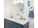 Bright bathroom featuring a new vanity with double sinks and modern fixtures at 7417 Seagull Way, Tampa, FL 33635