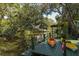 Waterfront dock with two kayaks and a ladder for swimming at 7417 Seagull Way, Tampa, FL 33635