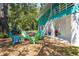 Charming home exterior with colorful chairs and lush landscaping, perfect for outdoor relaxation and entertaining at 7417 Seagull Way, Tampa, FL 33635