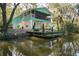 Waterfront home featuring a charming screened porch, dock, and a lush, picturesque landscape at 7417 Seagull Way, Tampa, FL 33635