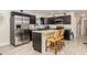 This modern kitchen offers a stainless refrigerator, breakfast bar and granite countertops at 7417 Seagull Way, Tampa, FL 33635