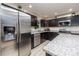The kitchen features stainless steel appliances, granite counters and dark wood cabinets at 7417 Seagull Way, Tampa, FL 33635