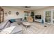 Relaxing living room featuring a comfortable gray sectional and a sliding door to the backyard at 7417 Seagull Way, Tampa, FL 33635